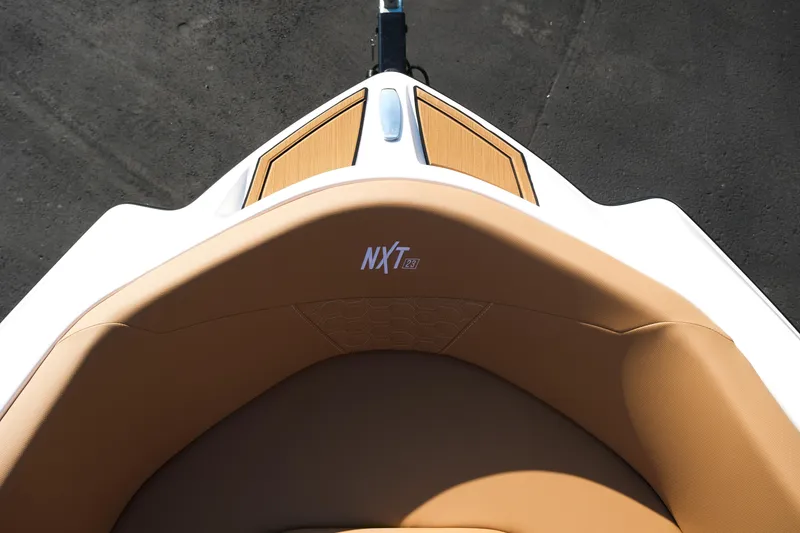 Slide: The Image of 2026 MasterCraft NXT23 boat bow with tan seating and sleek design. - 31