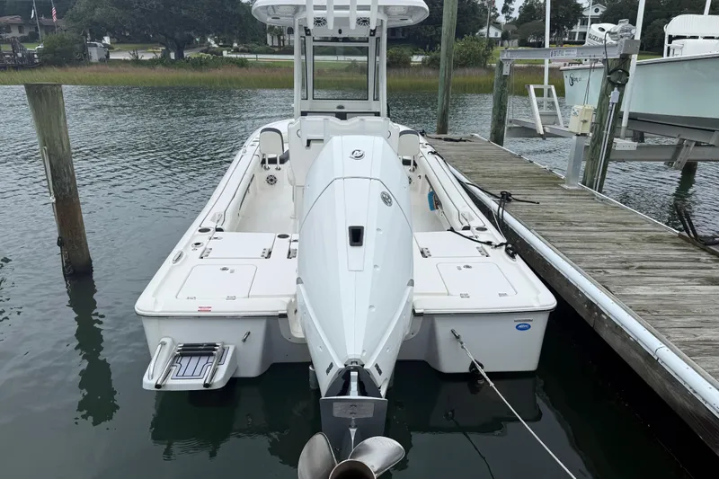 Slide: The Image of 2024 Tidewater 2500 Carolina Bay boat on calm water, clear sky background. - 10