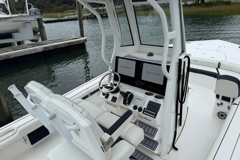 Slide: The Image of 2024 Tidewater 2500 Carolina Bay boat on calm water near shoreline. - 12