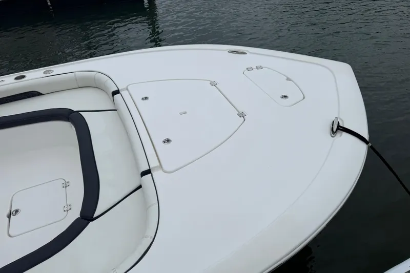 Slide: The Image of 2024 Tidewater 2500 Carolina Bay boat interior with seating and storage compartments. - 14
