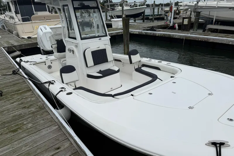 Slide: The Image of 2024 Tidewater 2500 Carolina Bay boat interior with modern navigation system on a sunny day. - 16