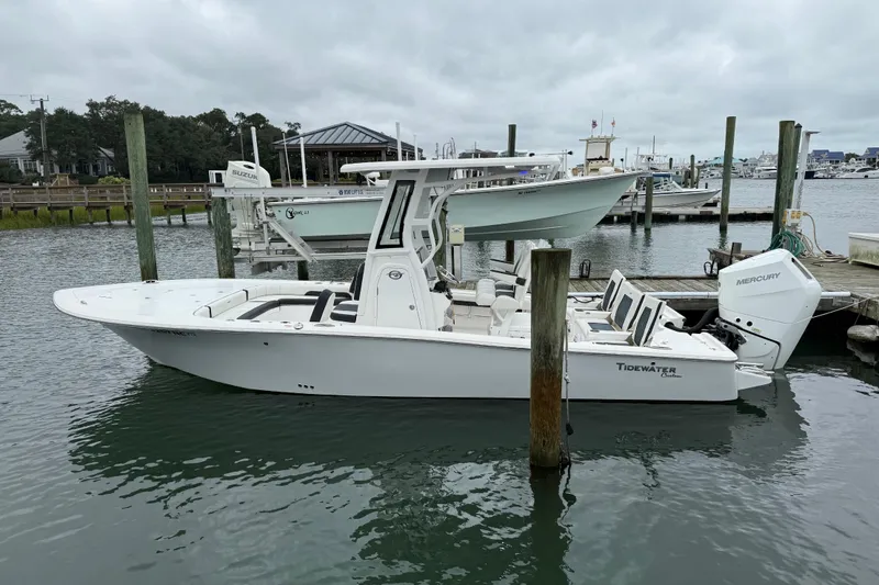 The Image of 2024 Tidewater 2500 Carolina Bay boat on water with Mercury engine, scenic background. - 2