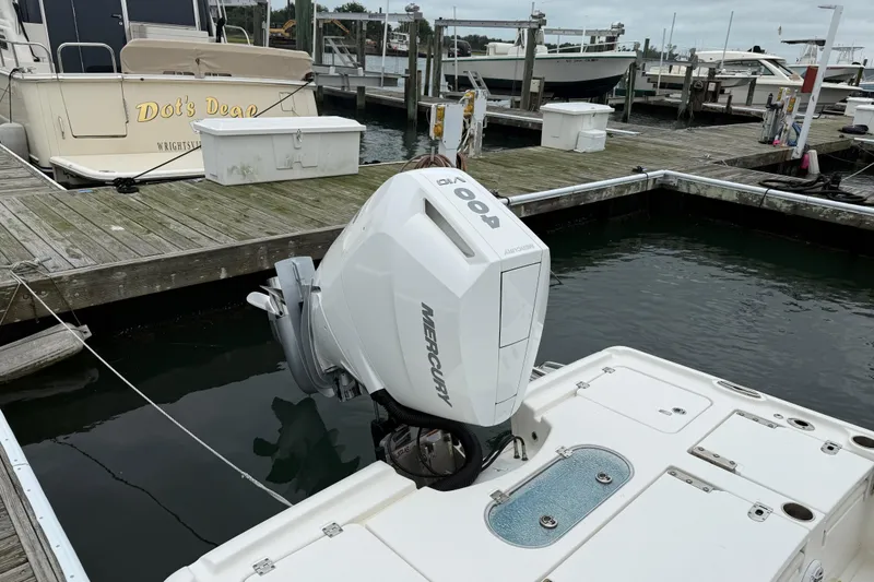 Slide: The Image of 2024 Tidewater 2500 Carolina Bay boat on water, featuring a Mercury outboard motor. - 20