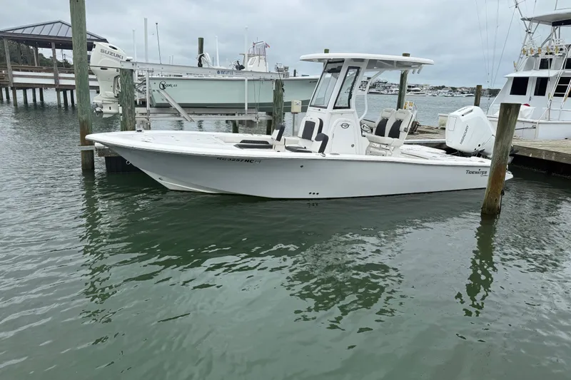 Slide: The Image of 2024 Tidewater 2500 Carolina Bay boat cruising on a serene waterway. - 6