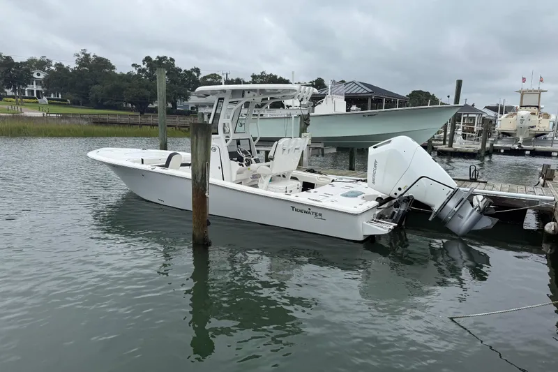 Slide: The Image of 2024 Tidewater 2500 Carolina Bay boat cruising on a serene lake. - 8