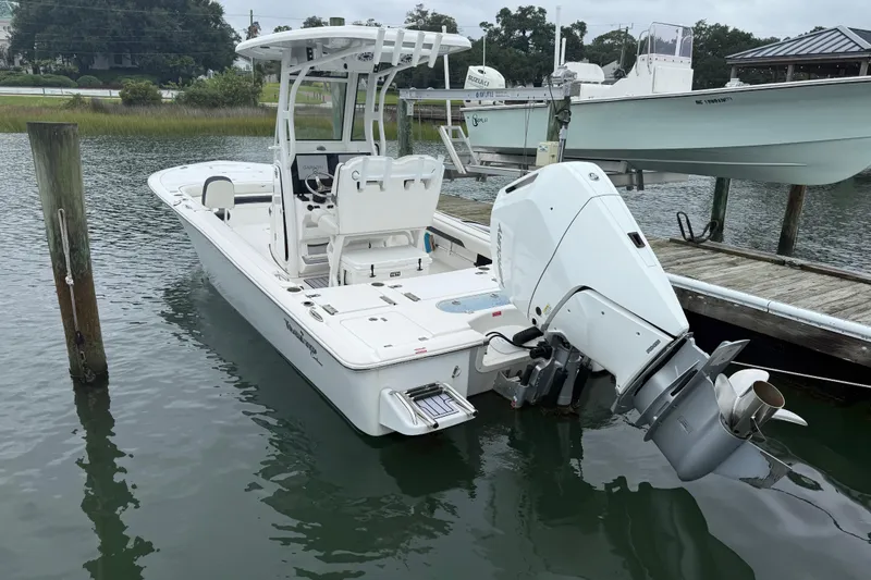 Slide: The Image of 2024 Tidewater 2500 Carolina Bay boat on water, featuring a Mercury outboard engine. - 9