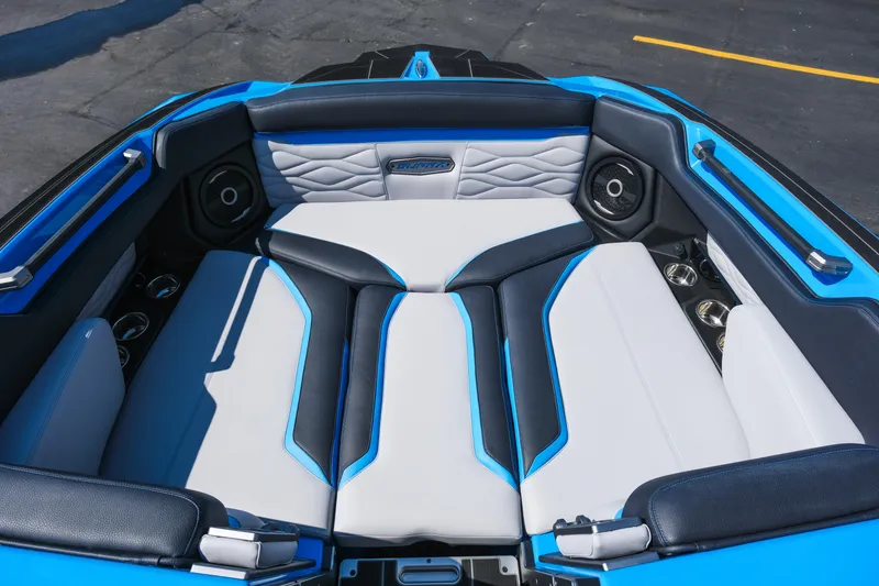 Slide: The Image of 2026 Supra SA450 boat interior with blue and white seating, featuring premium speakers. - 11