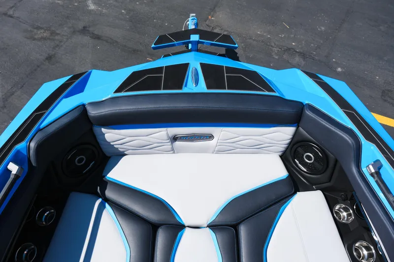 Slide: The Image of 2026 Supra SA450 boat interior with blue and white seating, speakers, and cup holders. - 12