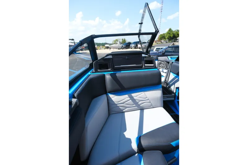 Slide: The Image of 2026 Supra SA450 boat interior with blue and gray seating, modern design, and open windshield. - 16
