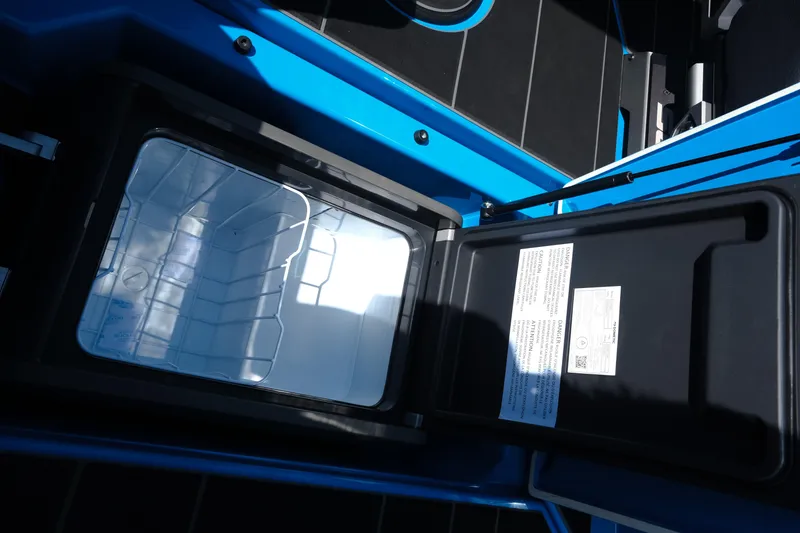 Slide: The Image of Open storage compartment in 2026 Supra SA450 boat, featuring a sleek blue design. - 20