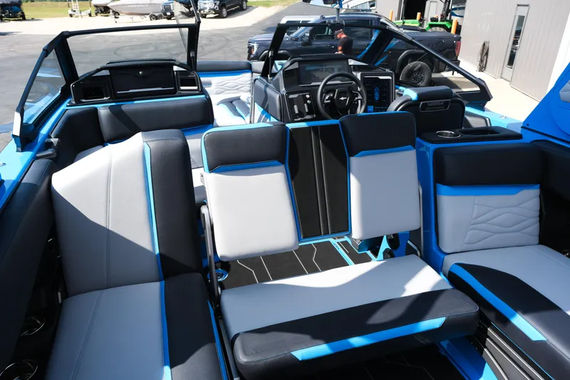Slide: The Image of 2026 Supra SA450 boat interior with modern blue and black seating, dashboard, and steering wheel. - 26