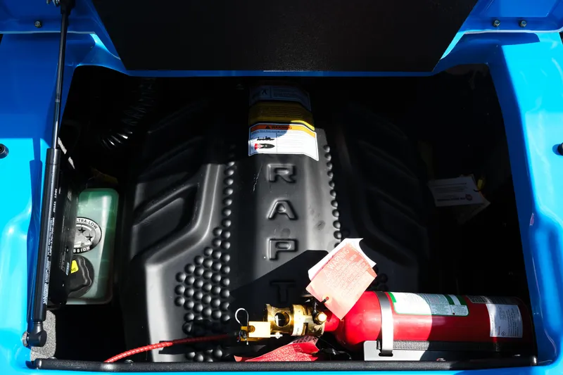 Slide: The Image of Engine compartment of 2026 Supra SA450 with fire extinguisher and blue exterior. - 28