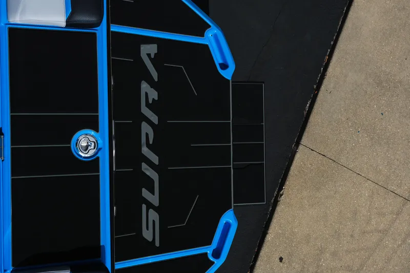 Slide: The Image of 2026 Supra SA450 boat deck with blue accents and logo. - 38