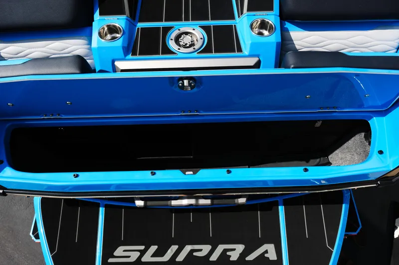 Slide: The Image of 2026 Supra SA450 boat interior with open storage compartment and cup holders. - 39