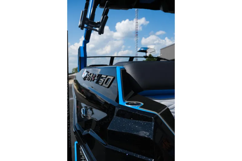 Slide: The Image of 2026 Supra SA450 boat, sleek design, blue and black accents, under a clear sky. - 41