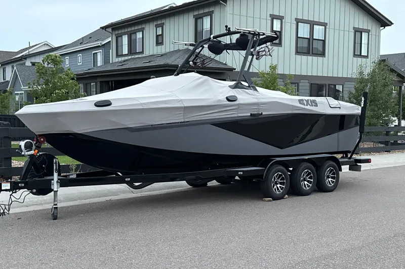 Slide: The Image of 2022 Axis T250 boat on trailer, covered, parked in residential area. - 0