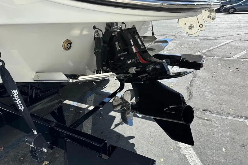 Slide: The Image of 2026 Sea Ray SDX 230 Surf boat with MerCruiser engine and propeller detail. - 12