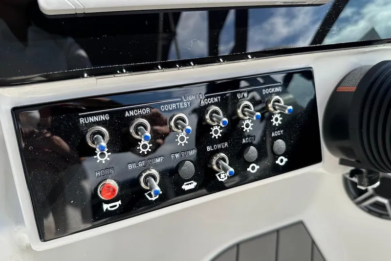 Slide: The Image of Control panel of 2026 Sea Ray SDX 230 Surf boat with various switches and buttons. - 26