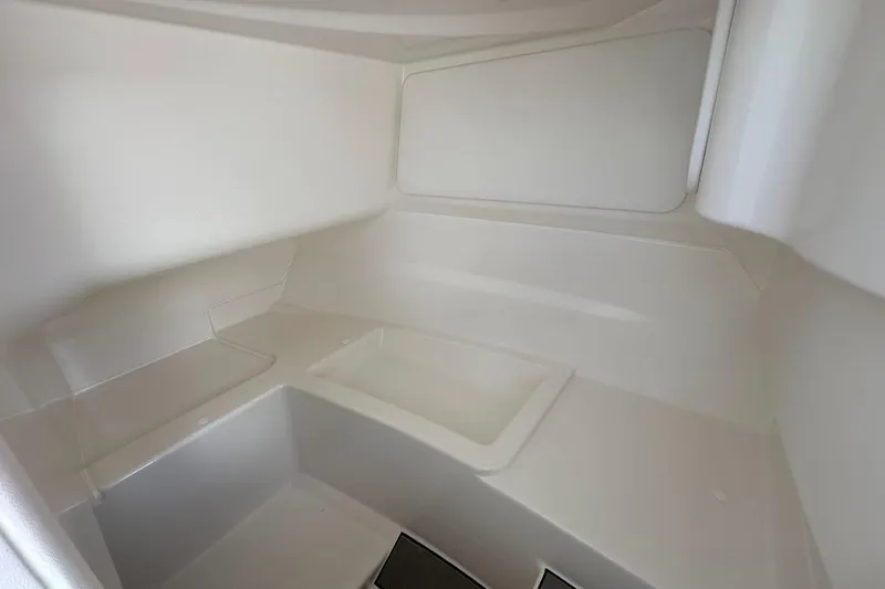 Slide: The Image of Interior of 2026 Sea Ray SDX 230 Surf boat, featuring sleek white design. - 33
