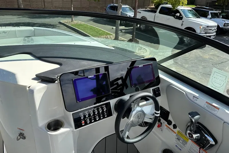 Slide: The Image of 2026 Sea Ray SDX 230 Surf boat dashboard with modern controls and steering wheel. - 44