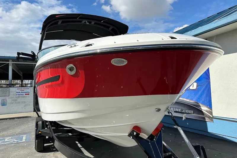 Slide: The Image of 2026 Sea Ray SDX 230 Surf boat with red and white hull on trailer. - 6