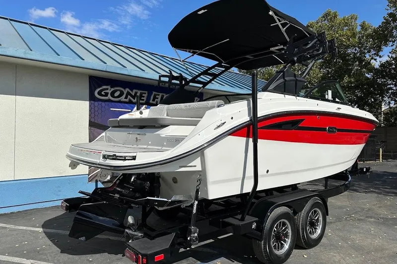 Slide: The Image of 2026 Sea Ray SDX 230 Surf boat on trailer, featuring sleek design and vibrant red accents. - 9