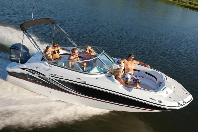 Slide: The Image of 2017 Hurricane SunDeck 2200 OB boat cruising with passengers on a lake. - 35