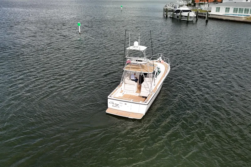 Slide: The Image of 2007 Tiara Yachts 3600 Open cruising on calm waters near a dock. - 22