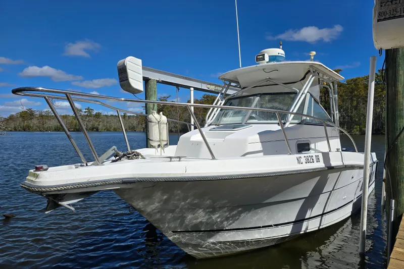 The Image of 1993 Robalo 2440 boat docked on a sunny day, featuring sleek design and sturdy build. - 1