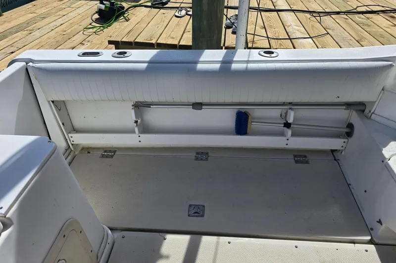 Slide: The Image of Interior of a 1993 Robalo 2440 boat showing seating and storage area. - 13