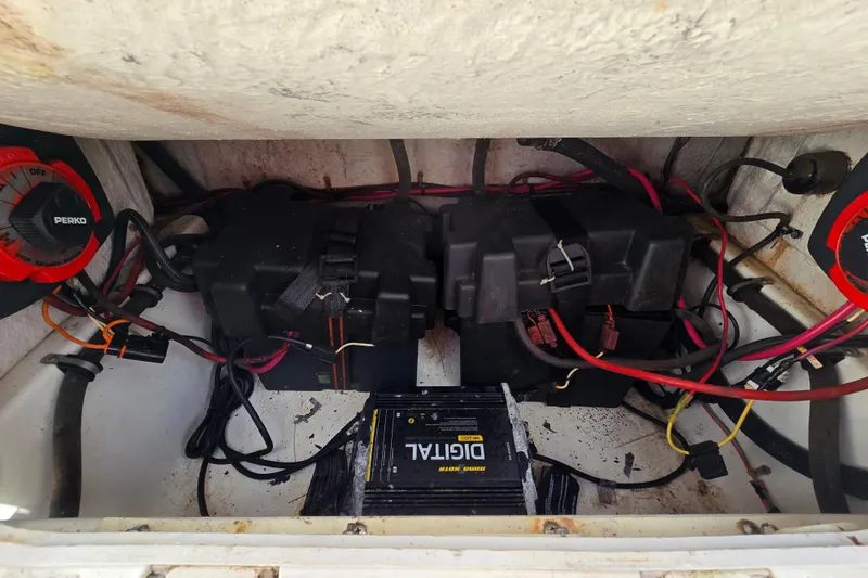 Slide: The Image of Battery compartment of 1993 Robalo 2440 boat with wiring and Perko switches. - 16