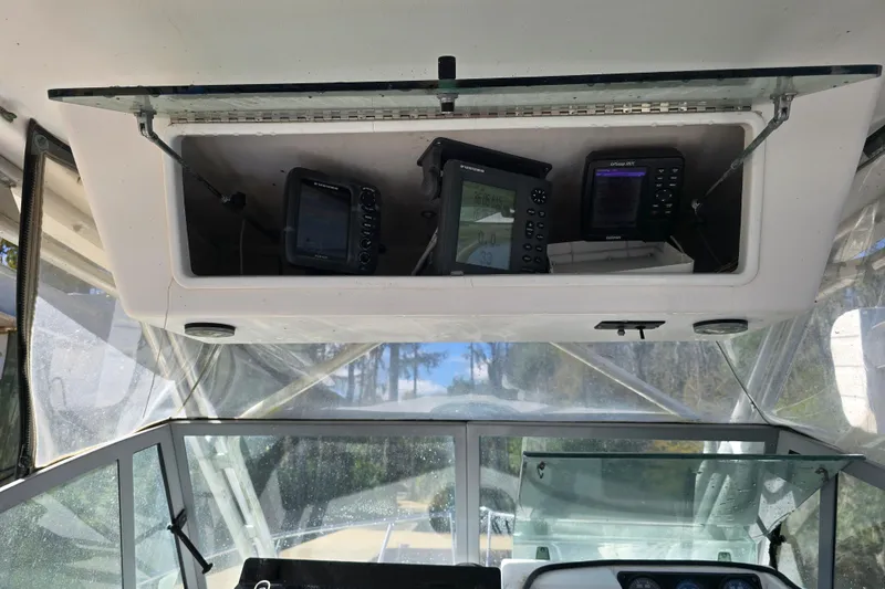 Slide: The Image of 1993 Robalo 2440 boat cockpit with navigation equipment and clear windshield view. - 20
