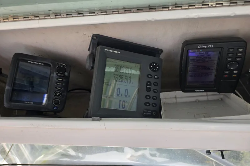 Slide: The Image of Marine navigation equipment on a 1993 Robalo 2440 boat dashboard, featuring Furuno and Garmin devices. - 21