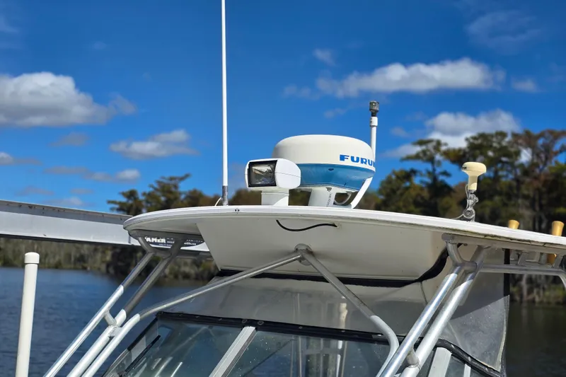 Slide: The Image of 1993 Robalo 2440 boat with radar equipment, set against a clear blue sky. - 26