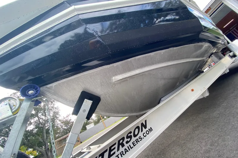 Slide: The Image of 2024 Sea King 260 boat on trailer, showcasing hull design and trailer branding. - 16