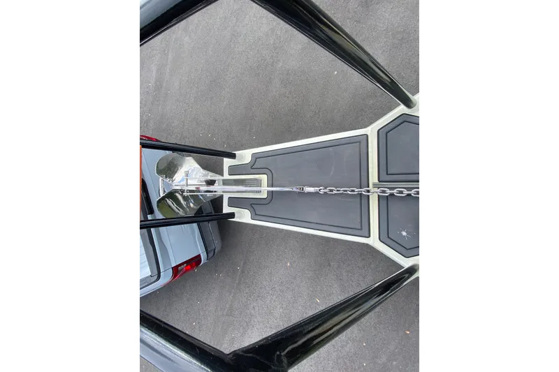 Slide: The Image of 2024 Sea King 260 boat trailer hitch with chain on asphalt surface. - 19
