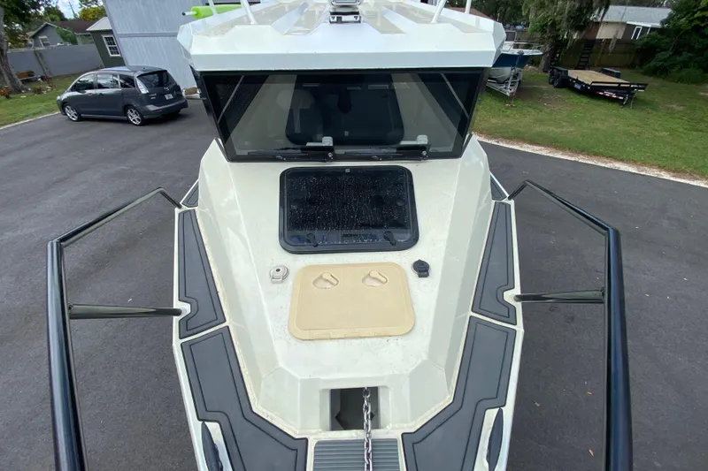 Slide: The Image of 2024 Sea King 260 boat on trailer, showing front deck and windshield. - 20