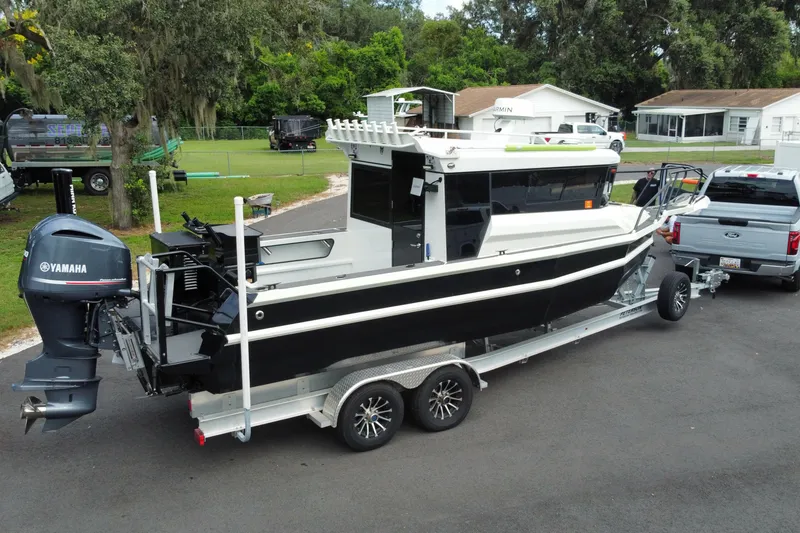 Slide: The Image of 2024 Sea King 260 boat on trailer, attached to a truck, with Yamaha outboard motor. - 27