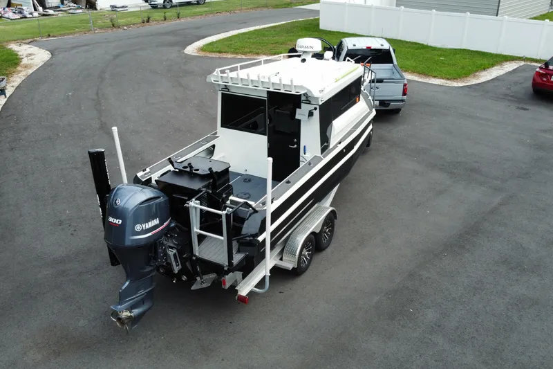 Slide: The Image of 2024 Sea King 260 boat on trailer, equipped with Yamaha 300 engine, parked on asphalt. - 28