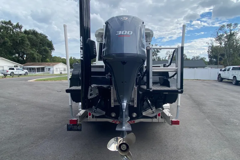 Slide: The Image of 2024 Sea King 260 boat with powerful 300 horsepower outboard motor, parked on a trailer. - 33