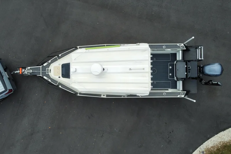 Slide: The Image of Overhead view of 2024 Sea King 260 boat on trailer, parked on asphalt. - 34