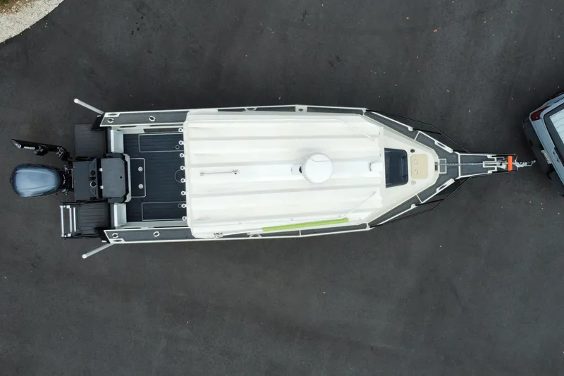 Slide: The Image of Overhead view of 2024 Sea King 260 boat on trailer, parked on asphalt. - 35