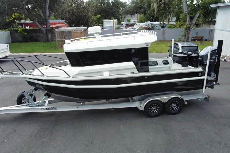 Slide: The Image of 2024 Sea King 260 boat on trailer, parked outdoors, side view. - 5