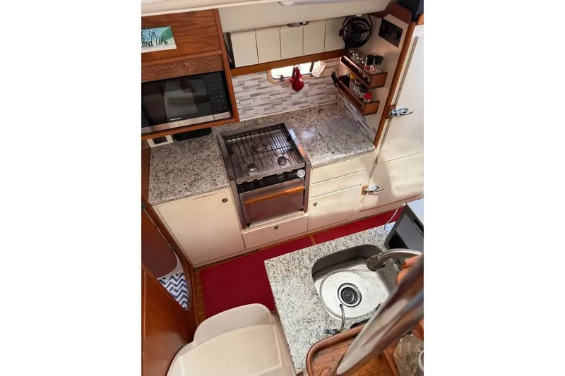 Slide: The Image of 1993 Jeanneau Lagoon 37 TPI Catamaran kitchen with granite countertops and modern appliances. - 7