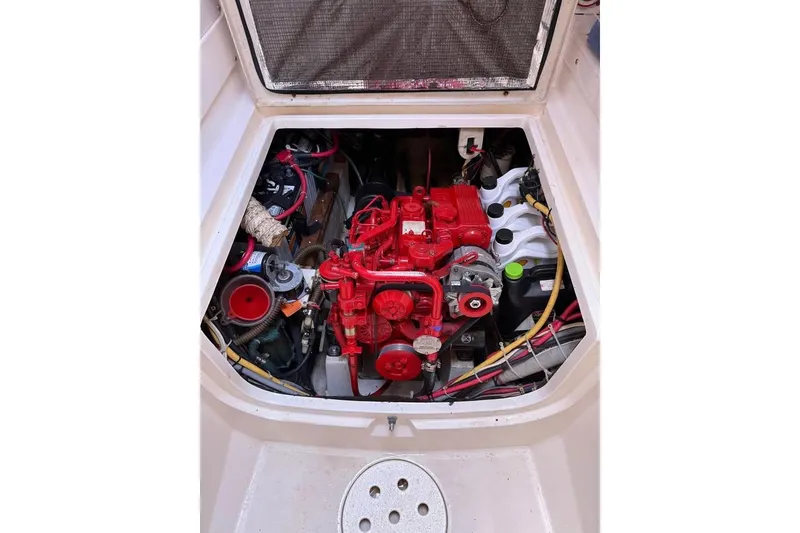 Slide: The Image of Engine compartment of a 1993 Jeanneau Lagoon 37 TPI Catamaran, featuring a red engine. - 8