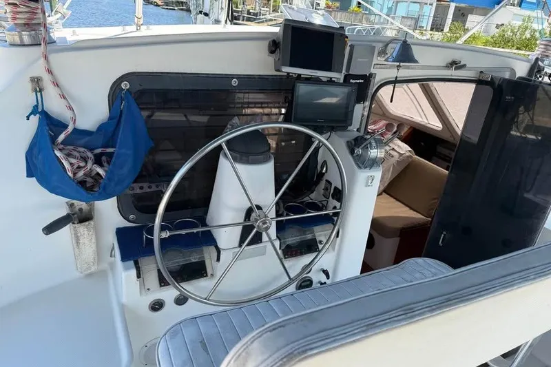 Slide: The Image of 1993 Jeanneau Lagoon 37 TPI Catamaran cockpit with steering wheel and navigation equipment. - 9