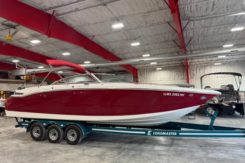 The Image of 2011 Cobalt 296 boat in a warehouse on a Loadmaster trailer. - 1