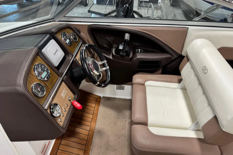 Slide: The Image of Interior of a 2011 Cobalt 296 boat featuring a sleek dashboard and comfortable seating. - 12