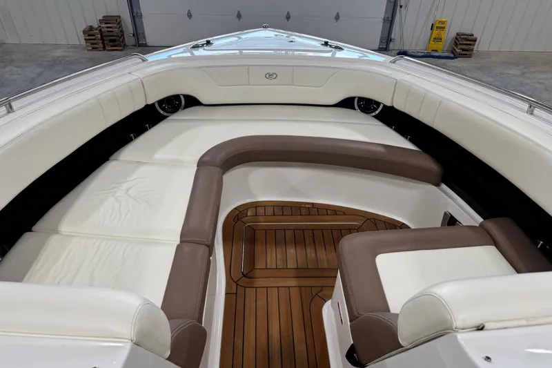 Slide: The Image of 2011 Cobalt 296 boat interior with white and brown seating, wooden flooring. - 13