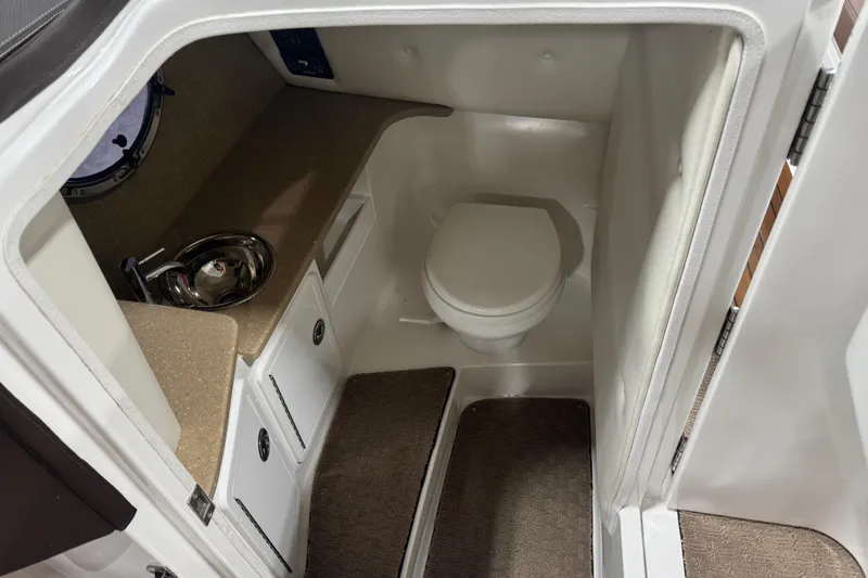 Slide: The Image of Interior of 2011 Cobalt 296 boat bathroom with toilet and sink. - 14